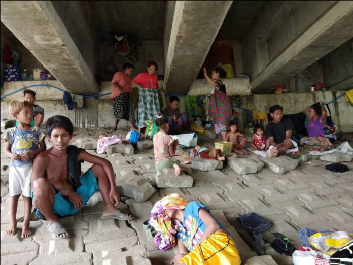 UNDER THE BRIDGE. These Badjaos have found a sturdy refuge under this bridge in Barangay Buhang, Jaro, Iloilo City. Conflict between Muslim separatists and government troops in Mindanao has forced them to flee to Iloilo City. PSTMO PHOTO