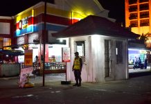 NIGHT SENTINEL. A policeman guards the entrance of Smallville Complex in Mandurriao, Iloilo City. Smallville is a popular strip of bars, restaurants and discotheques. Panay News Photo