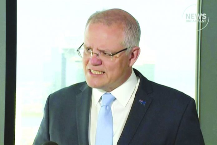 In this image made from video, Australian Prime Minister Scott Morrison speaks in Osaka, western Japan, Friday, June 28, 2019. Morrison said he remained concerned for an Australian student who is uncontactable in North Korea and has been offered international support to find him. ABC via AP