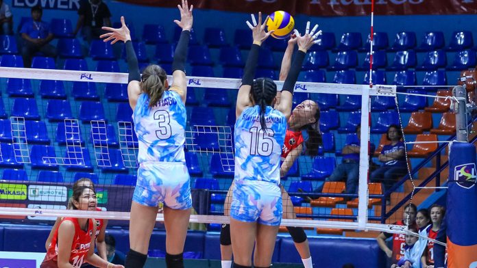 Petron Blaze Spikers’ Cherry Rondina directs her shot to the defense of Foton Tornadoes’ Dindin Santiago-Manabat. PSL