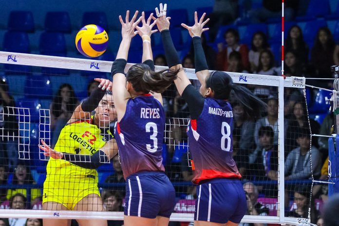 F2 Logistics Cargo Movers’ Kalei Mau attempts to score over the defense of Petron Blaze Spikers’ Mika Reyes and Aiza Maizo-Pontillas. PSL PHOTO