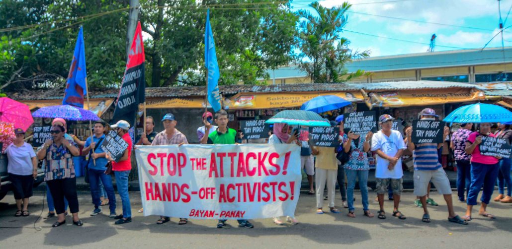 CAN’T SILENCE THEM. Protesters call for a stop to the harassment and intimidation of activists during a picket on July 8, 2019 in front of the Police Regional Office in Iloilo City. IAN PAUL CORDERO/PN