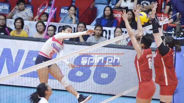 Creamline Cool Smashers scores a hit against two Petro Gazz Angels defenders. SPIN PH