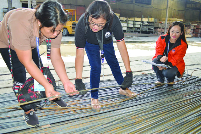 Commissioned personnel of the Department of Trade and Industry inspect these steel bars at a random hardware shop in Iloilo City on Friday, July 5. DTI REGION 6