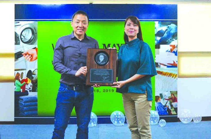 The prestigious Fred Maytag Award for outstanding achievement with Mr. John Sioco, (left) operations director and Ms. Windy Punzalan, (right) brand manager.