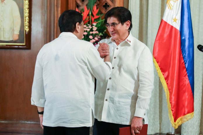 President Rodrigo Roa Duterte congratulates newly appointed Information and Communications Technology Secretary Gregorio Honasan II during the oath-taking ceremony at the Malacañan Palace on July 1, 2019. PRESIDENTIAL PHOTO