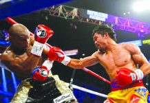 Manny Pacquiao throws a right at Floyd Mayweather Jr. during their welterweight unification championship bout on May 2, 2015 at the MGM Grand Garden Arena in Las Vegas, Nevada. Mayweather won.