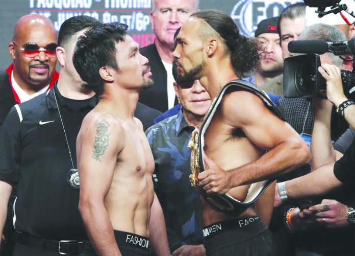 WHO WILL BLINK FIRST? Manny Pacquiao and Keith Thurman stare at each other after their weigh in yesterday in Las Vegas, Nevada, USA. AP