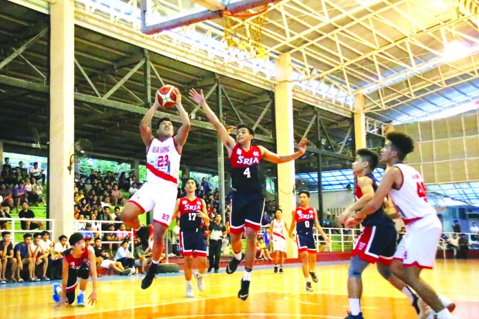 Hua Siong College of Iloilo Red Phoenix’s Reneil Gamboa hangs in the air for an inside hit. WINMEL LEE