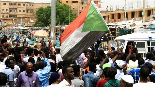 Sudanese people chant slogans and wave Sudanese flags during a demonstration in Khartoum, Sudan. REUTERS