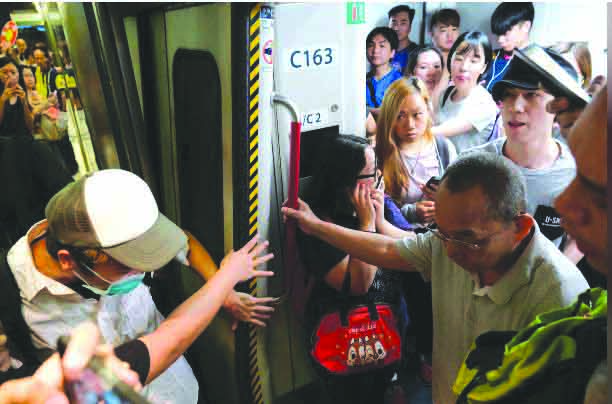 Anti-extradition bill demonstrators block the Mass Transit Railway (MTR) train in Hong Kong, China July 30, 2019. REUTERS