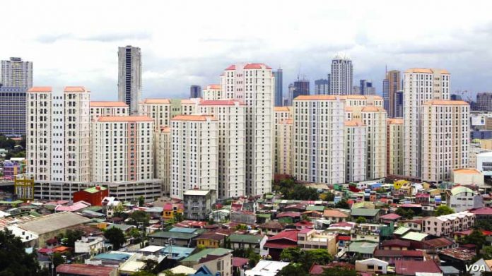 Rows of condominium building are seen behind a middle-class residential district in Mandaluyong, Metro Manila. The growth of the Philippine economy is expected to finish strong this year because government spending is back on track. VOICE OF AMERICA