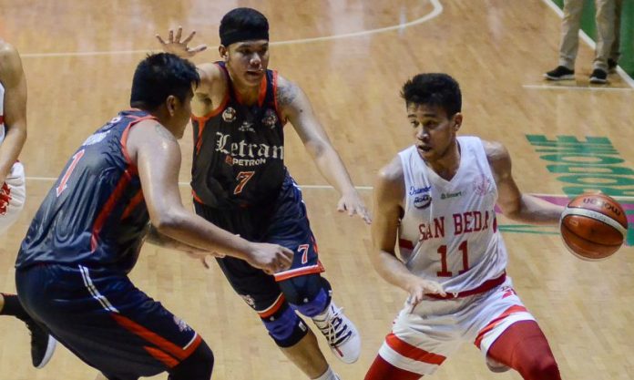 Ilonggo Clint Doliguez of San Beda University Red Lions picked up his dribble after being hounded by two Letran Knights defenders. TIEBREAKER TIMES PHOTO