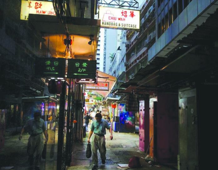 A man walks down an alley filled with stalls in the Central business district in Hong Kong, China Aug. 22, 2019. REUTERS