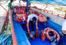 BOAT INSPECTION. A Philippine Coast Guard personnel inspects the safety equipment of this motorboat plying the Iloilo-Guimaras route. Do motorboats crossing the Iloilo Strait have, among others, enough lifejackets for their passengers? IAN PAUL CORDERO/PN