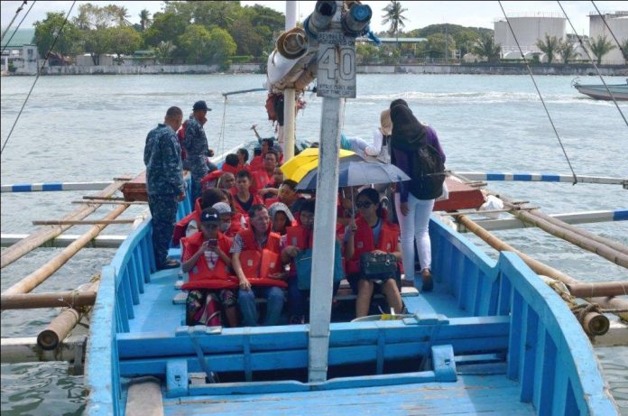 WEARING LIFEJACKET IS A MUST. Philippine Coast Guard personnel make sure the passengers of this Guimaras-bound motorboat are wearing lifejackets before leaving the Iloilo Ferry Terminal. Passengers should wear lifejackets at all times throughout the voyage, according to the Maritime Industry Authority. IAN PAUL CORDERO/PN