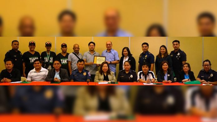 Bacolod City vice mayor El Cid Familiarian awards the Outstanding Barangay Tanod certificate to Barangay Singcang Airport received by Barangay Captain Rosini Distrito and the members of the barangay tanods with POC members as witnessed in the awarding rites. PIA