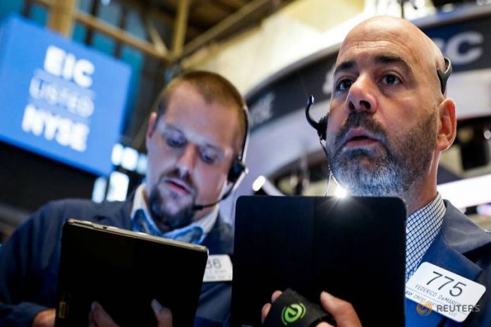 Traders work on the floor at the New York Stock Exchange (NYSE) in New York, U.S., August 7, 2019. REUTERS