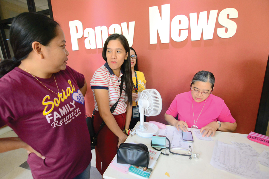 Panay News field reporters Ime and Glenda wait as Dr. Gemma computes their respective body mass index.