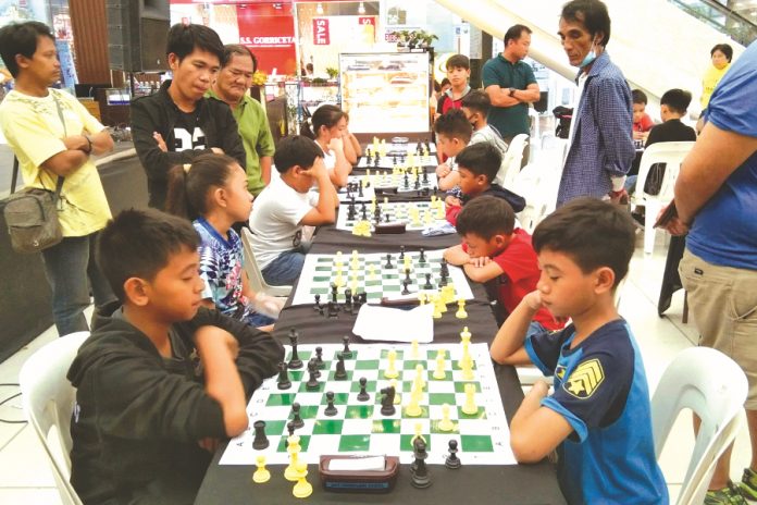 Elementary chess players in action during the 2019 Inter-Elementary School Dalawahan Chess Competition at the GT Town Center in Pavia, Iloilo. PAVIA CHESSERS PHOTO