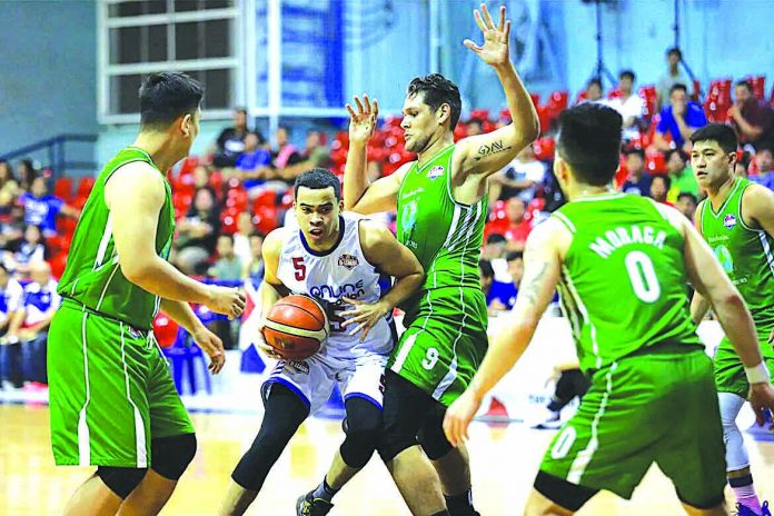 Aaron Black of AMA Online Education Titans extricates himself against the Hazchem Green Warriors defenders. PBA PHOTO