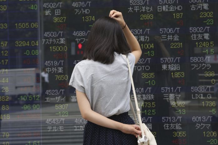 A woman looks at an electronic stock board of a securities firm in Tokyo, Monday, Sept. 2, 2019. Asian stocks are mixed yesterday after Washington and Beijing escalated their trade war with new tariff hikes. AP/KOJI SASAHARA