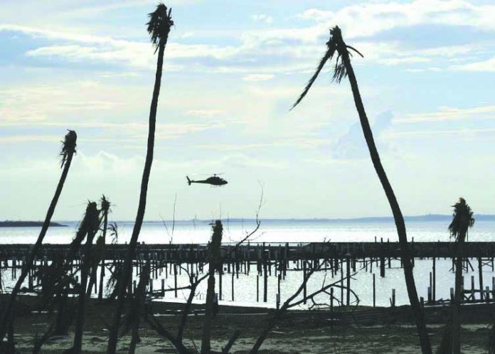 An unidentified helicopter lands to deliver food and water in the aftermath of Hurricane Dorian on the Great Abaco island town of Marsh Harbour, Bahamas, Sept. 4, 2019. Reuters