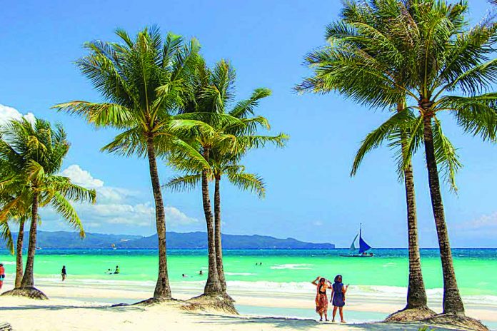 Tourists are seen in the front beach of Boracay Island in Malay, Aklan. The Department of Tourism says 95 percent of establishments in the famed-island resort are now fully compliant with its regulations. CONTRIBUTED PHOTO