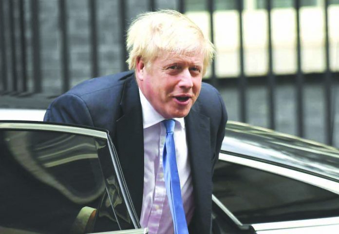 Britain's Prime Minster Boris Johnson arrives at 10 Downing Street, in London, Wednesday, Sept. 25, 2019. AP