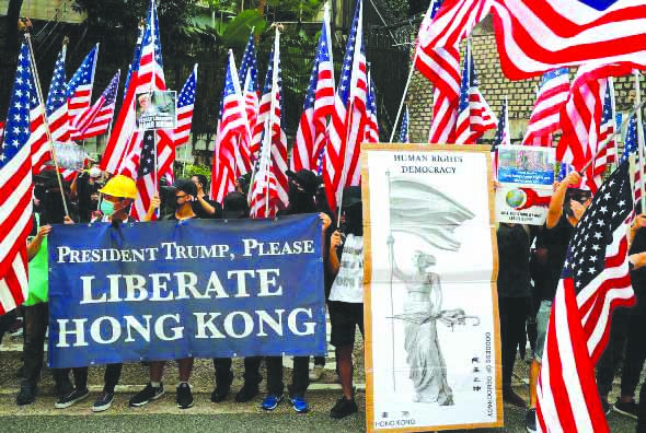 Protesters hold signs and U.S. flags during a rally in Hong Kong, China on Sept. 8, 2019. REUTERS