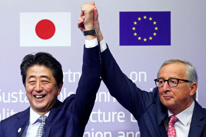 European Commission President Jean-Claude Juncker (right) and Japan's Prime Minister Shinzo Abe gesture during the conference Communication Connecting Europe and Asia, in Brussels, Belgium, on Friday. Reuters