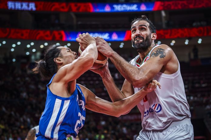 The Philippines’ Japeth Aguilar’s is hit with the ball on the face as he tries to steal it from Iran’s Hamed Haddadi. FIBA PHOTO