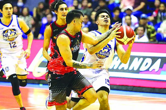 Kiefer Ravena of NLEX Road Warriors is hacked by Phoenix Fuel Masters’ Ryan Roose Garcia. PBA PHOTO