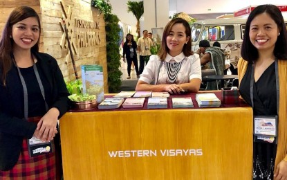 Negros Occidental supervising tourism operations officer Cristine Mansinares (right) with the Department of Tourism-Western Visayas staff during the 30th Philippine Travel Mart at the SMX Convention Center at Mall of Asia Complex in Pasay City. PNA