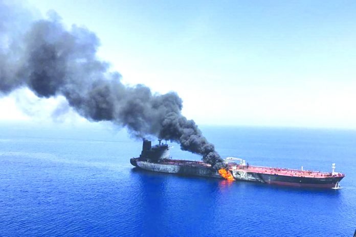 In this June 13, 2019 file photo, an oil tanker is on fire in the Gulf of Oman. The U.S. Navy is trying to put together a new coalition of nations to counter what it sees as a renewed maritime threat from Iran. AP