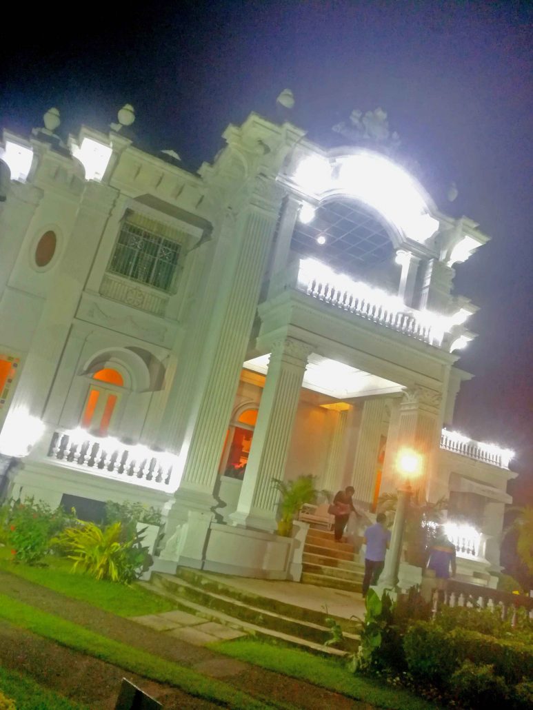 The Lopez Heritage House in Nelly’s Garden illuminated at night.