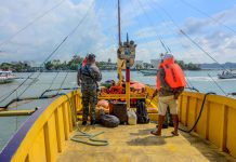 A Philippine Coast Guard personnel (standing, left) is making sure all the passengers of this Guimaras-bound motorboat are wearing lifejackets before allowing the boat to leave the Iloilo Ferry Terminal in Iloilo City. The lifejackets must be worn at all times throughout the voyage. IAN PAUL CORDERO/PN