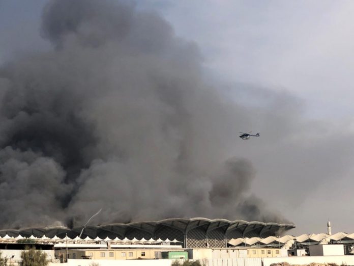 A firefighting helicopter sprays water on a fire at the Haramain high-speed rail station in Jeddah, Saudi Arabia on Sept. 29. REUTERS/ISMAIL NOFAL