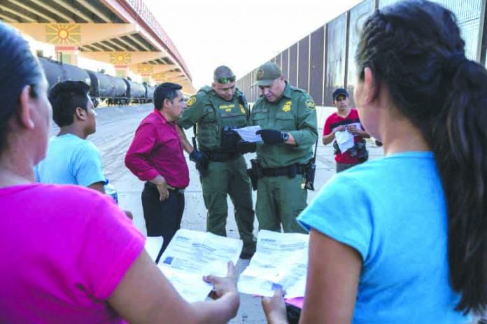 US Customs and Border Protection agents in May 2019 check documents in El Paso, Texas, from a small group of migrants who crossed from Mexico. AFP