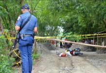 AMBUSH SITE. A policeman inspects this crime scene in Barangay Cabugao Norte, Santa Barbara, Iloilo where a farmer was fatally ambushed while driving his motorcycle yesterday morning, Sept. 11, 2019. Probers say the attack could have been sparked by a land dispute. IAN PAUL CORDERO/PN