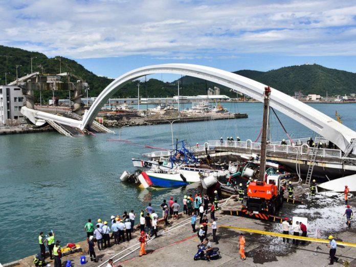 Rescuers work near the site of a collapsed bridge in Nanfangao, eastern Taiwan on Oct. 1, 2019. AP