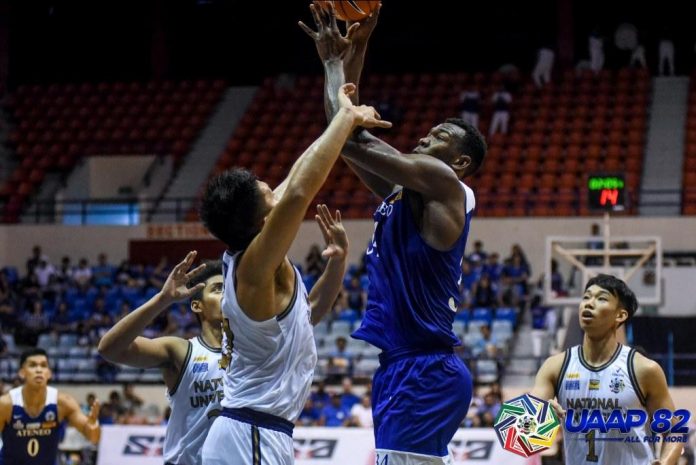 Ateneo Blue Eagles’ Angelo Kouame attempts a hook shot against a National University Bulldogs defender. UAAP PHOTO