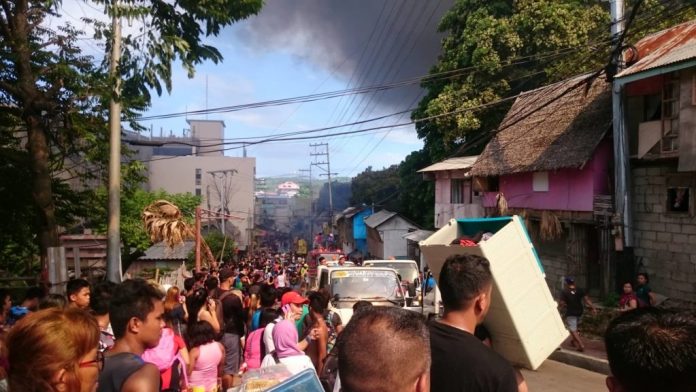 Residents crowd the street after fire gutted their houses in Station 3, Barangay Manoc-Manoc, Boracay Island, Malay, Aklan on Oct. 24. No one was injured in the incident. RADYO TODO/PN