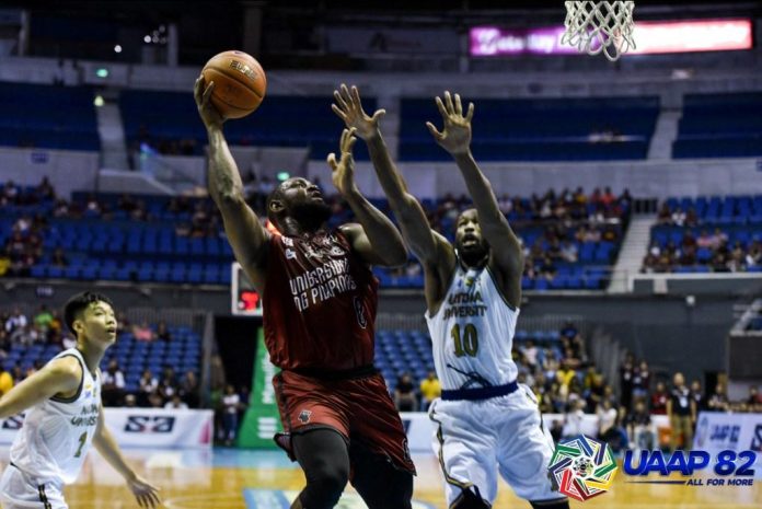 University of the Philippines Fighting Maroons’ Bright Akhuetie attempts a one-hander over Adamson University Falcons’ Lenda Douanga. UAAP PHOTO