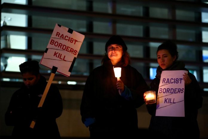 Anti-racism campaigners take part in a vigil, following the discovery of 39 bodies in a truck container on Wednesday, outside the Home Office in London, Britain on Oct. 24. REUTERS/HANNAH MCKAY