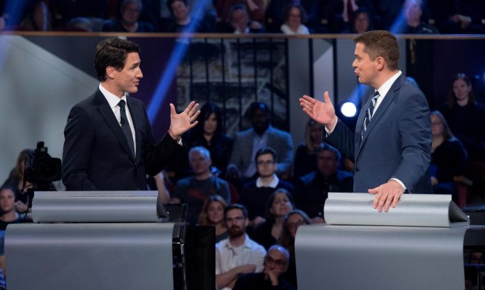 Conservative leader Andrew Scheer and Liberal leader Justin Trudeau gesture to each other as they both respond during the Federal leaders’ debate in Gatineau, Quebec, Canada on Oct. 7. JUSTIN TANG/POOL VIA REUTERS