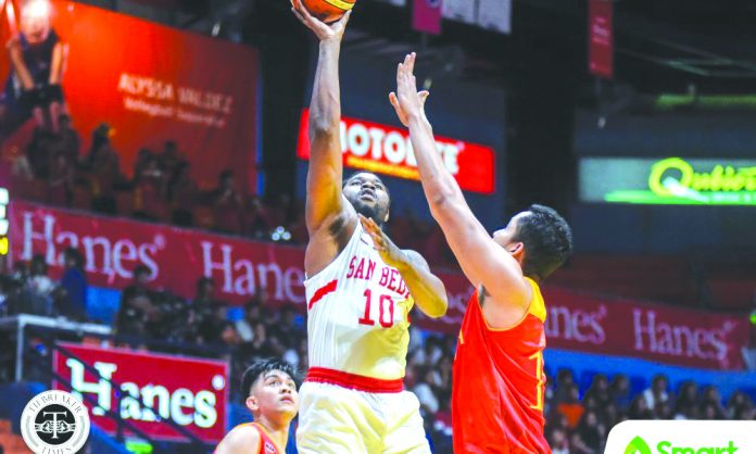 San Beda University Red Lions’ Donald Tankoua scores inside against a Mapua University Cardinals defender. TIEBREAKER TIMES PHOTO