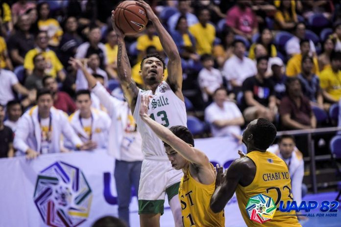 De La Salle University Green Archers’ Jamie Malonzo snatches the rebound from University of Santo Tomas Growling Tigers defenders. UAAP PHOTO