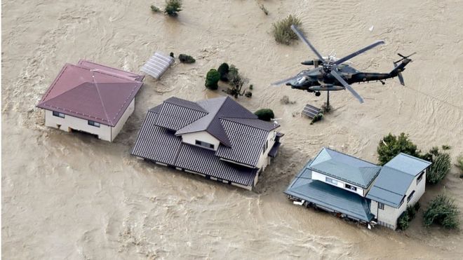 An aerial view shows a Japan Self-Defense Force helicopter flying over residential areas flooded by the Chikuma river following Typhoon Hagibis in Nagano, central Japan on Oct. 13 in this photo taken by Kyodo. MANDATORY CREDIT KYODO/VIA REUTERS