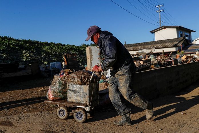 A man cleans debris in the aftermath of Typhoon Hagibis in Yanagawamachi district, Date City, Fukushima prefecture, Japan Oct. 16. SOE ZEYA TUN/REUTERS